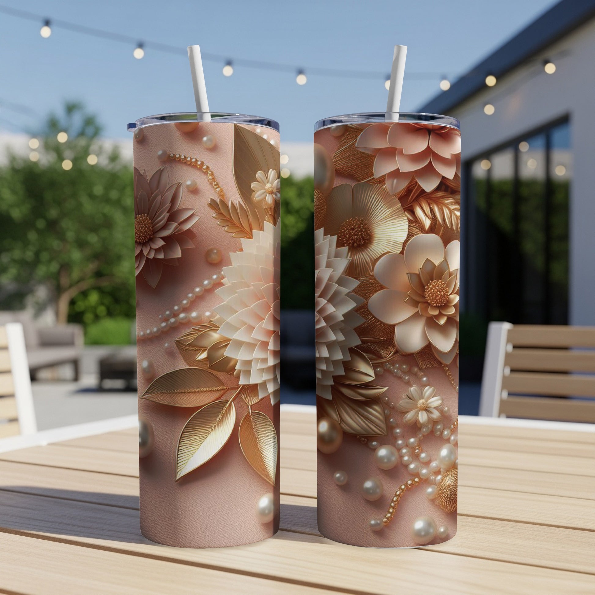 Two tall, skinny tumblers with ornate floral and pearl designs on a table.