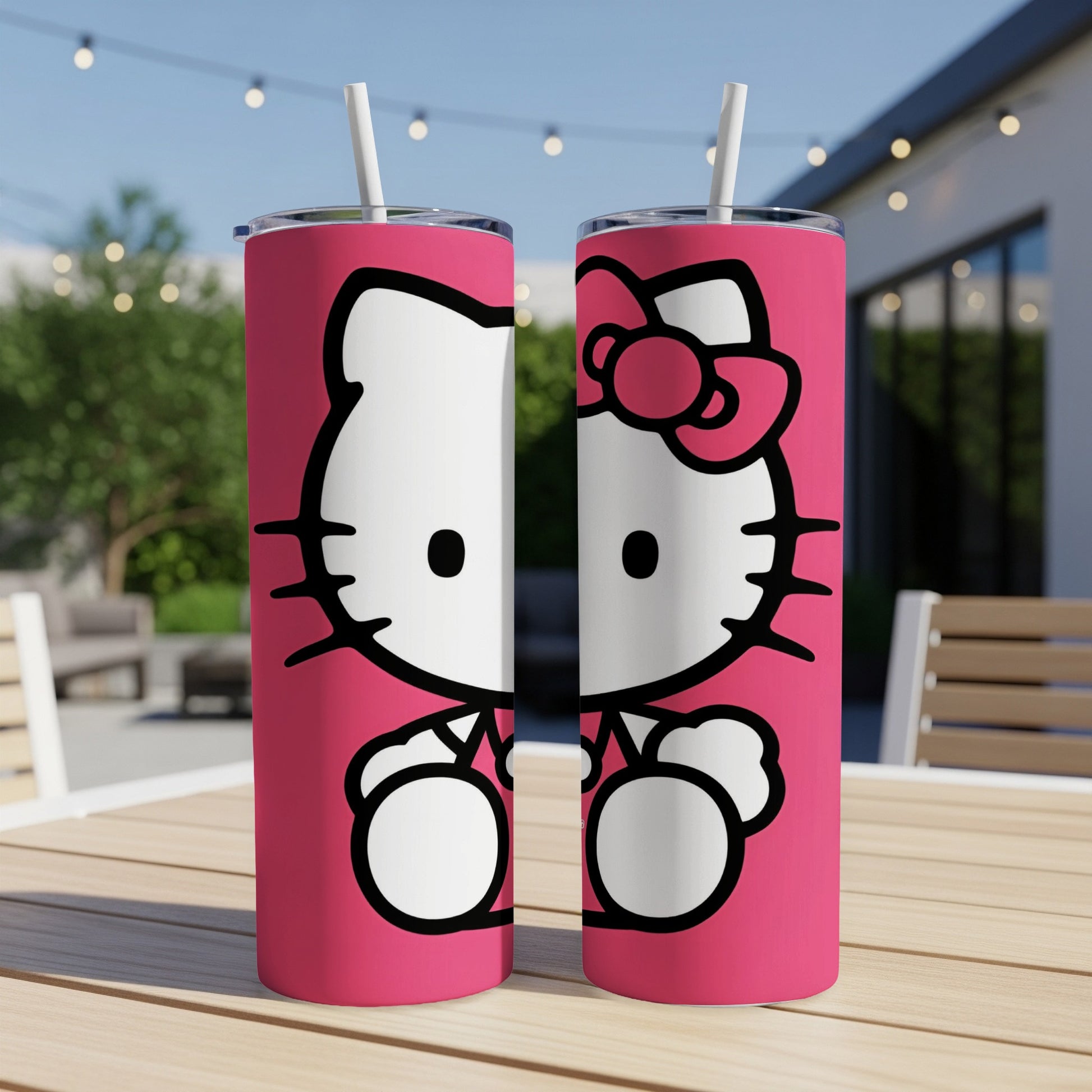 Two pink tumblers with Hello Kitty designs on a wooden table.