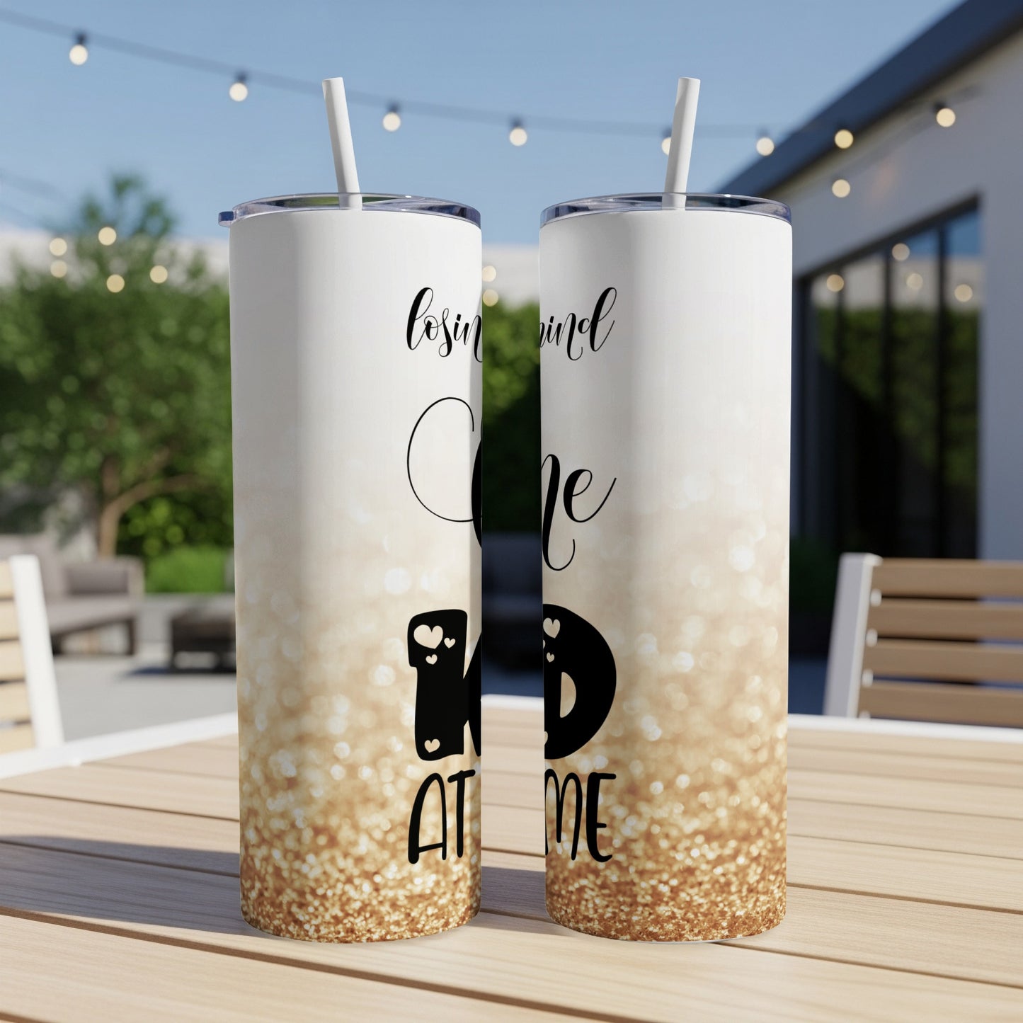 Two tall tumblers with "lovin' mind ID AT ME" text and gold glitter design.