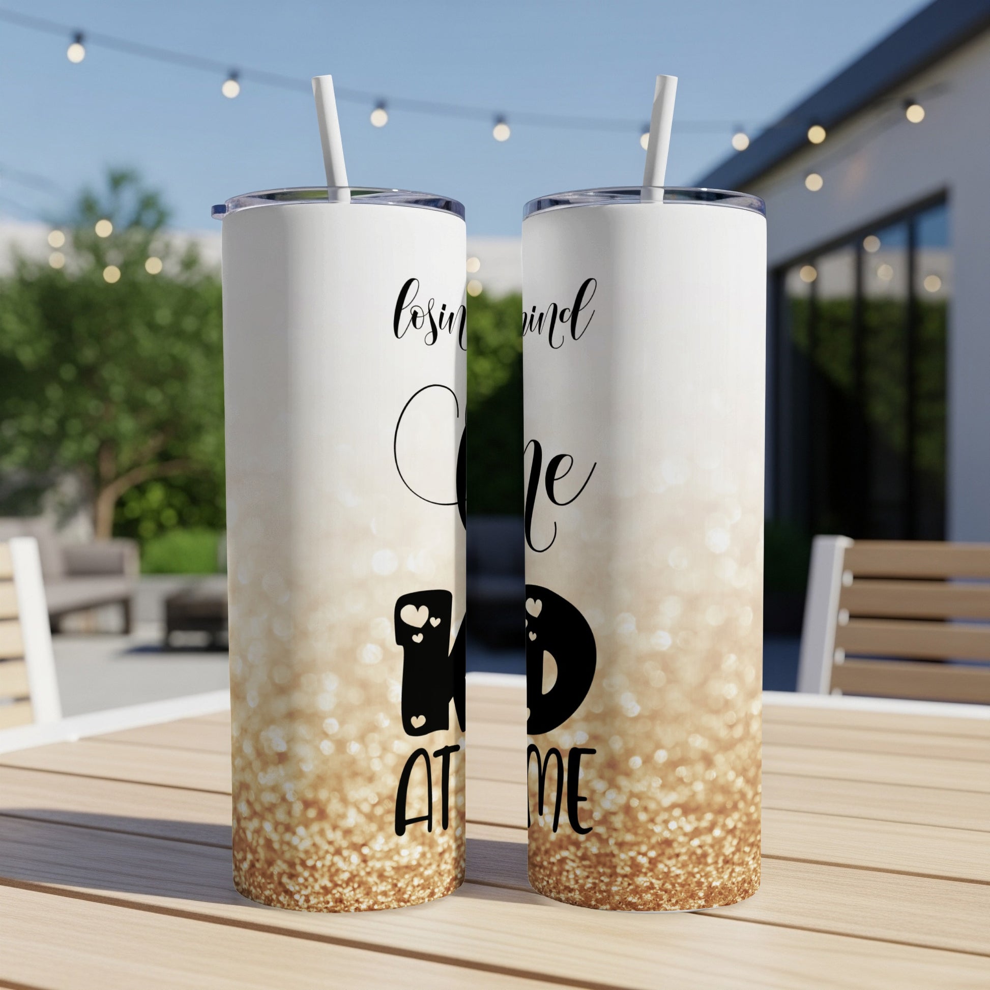 Two tall tumblers with "lovin' mind ID AT ME" text and gold glitter design.