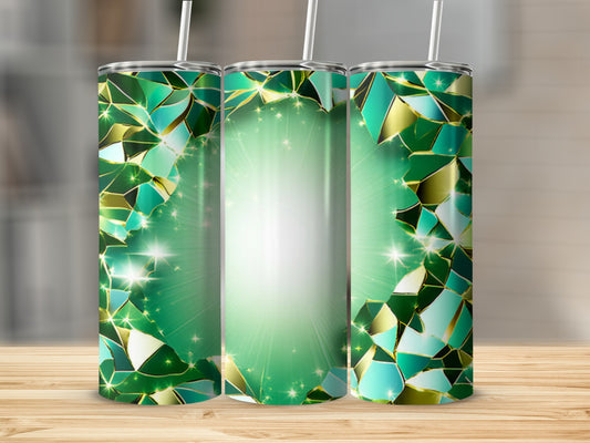 Green mosaic pattern tumbler with straw on wooden surface.