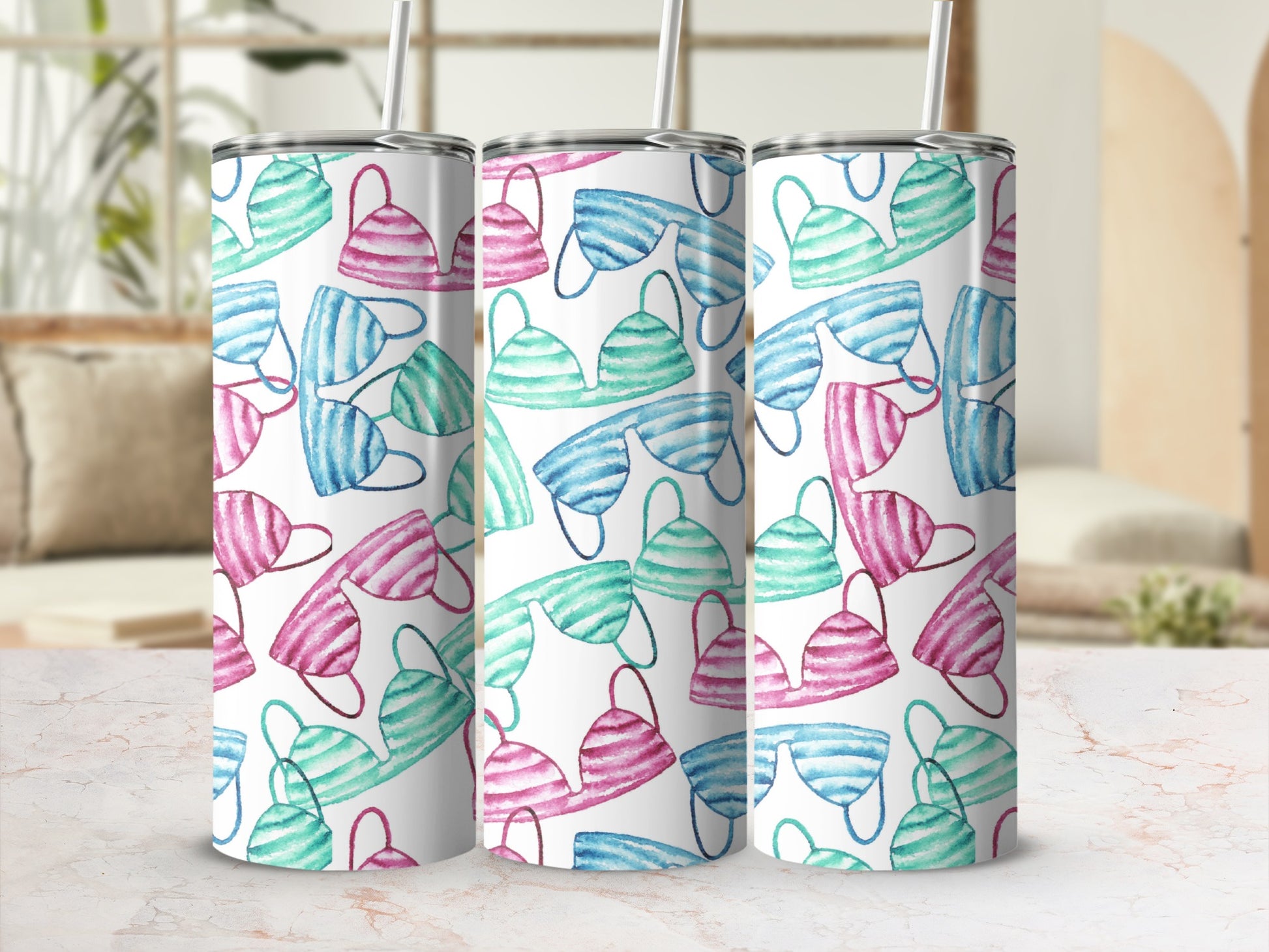 Three tumblers with a pink and teal watercolor bikini pattern.
