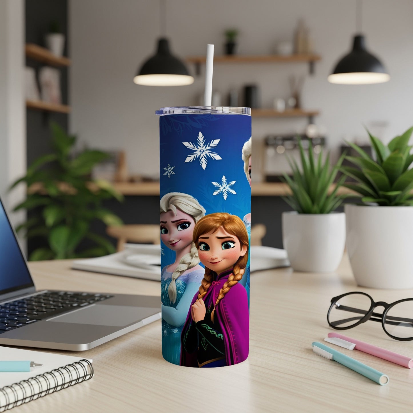 Elsa and Anna from Frozen on a blue tumbler with snowflakes.