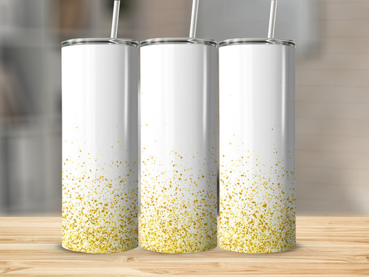Three white tumblers with gold glitter splatter on a wooden surface.