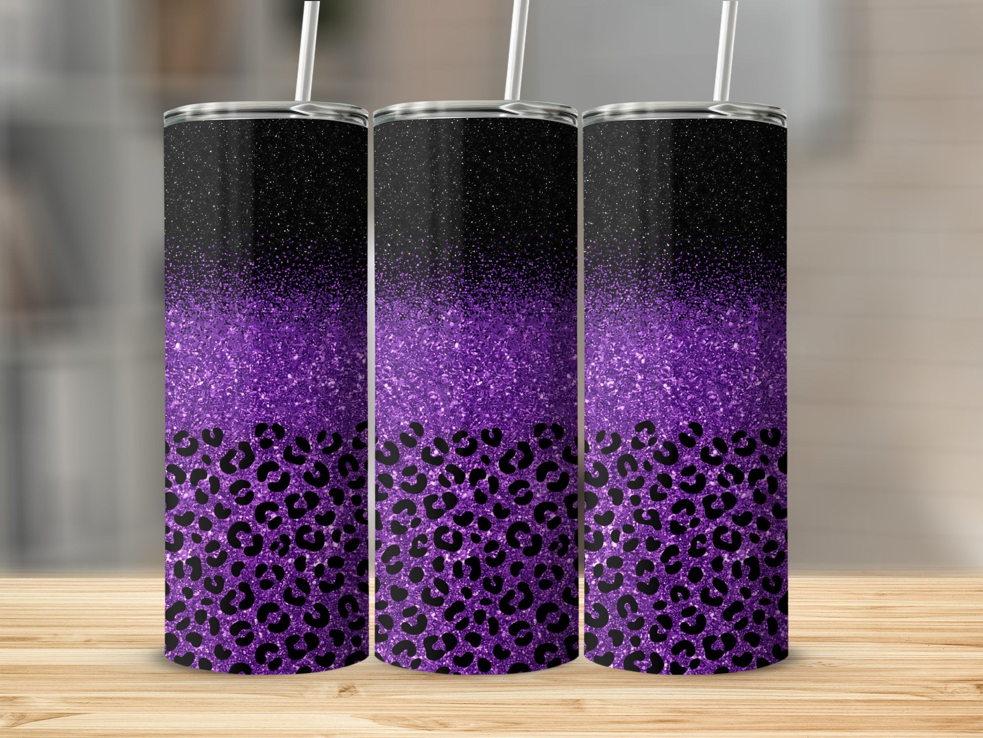 Three tumblers with purple glitter and black leopard print.