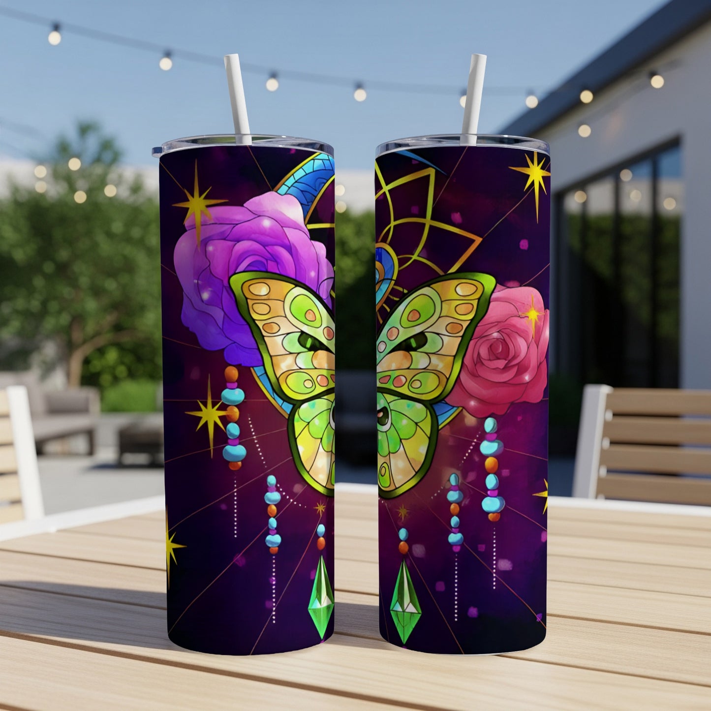 Two patterned tumblers with butterflies, roses, and celestial designs.
