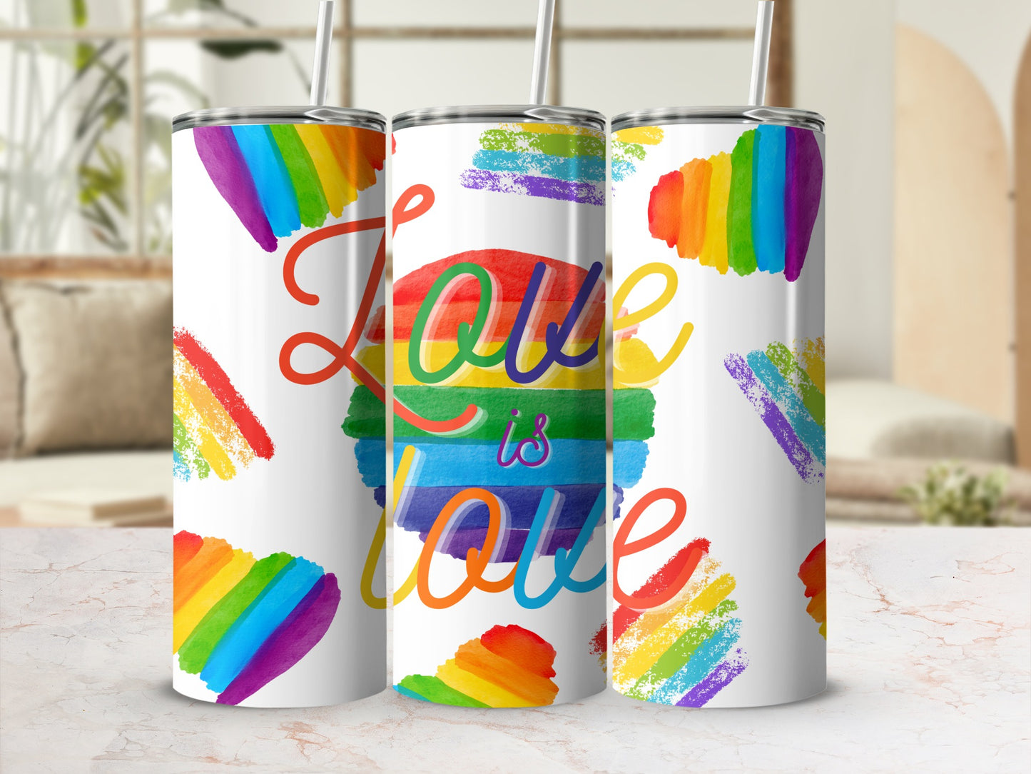 Rainbow pride love is love tumbler with straws and abstract rainbow brush strokes.