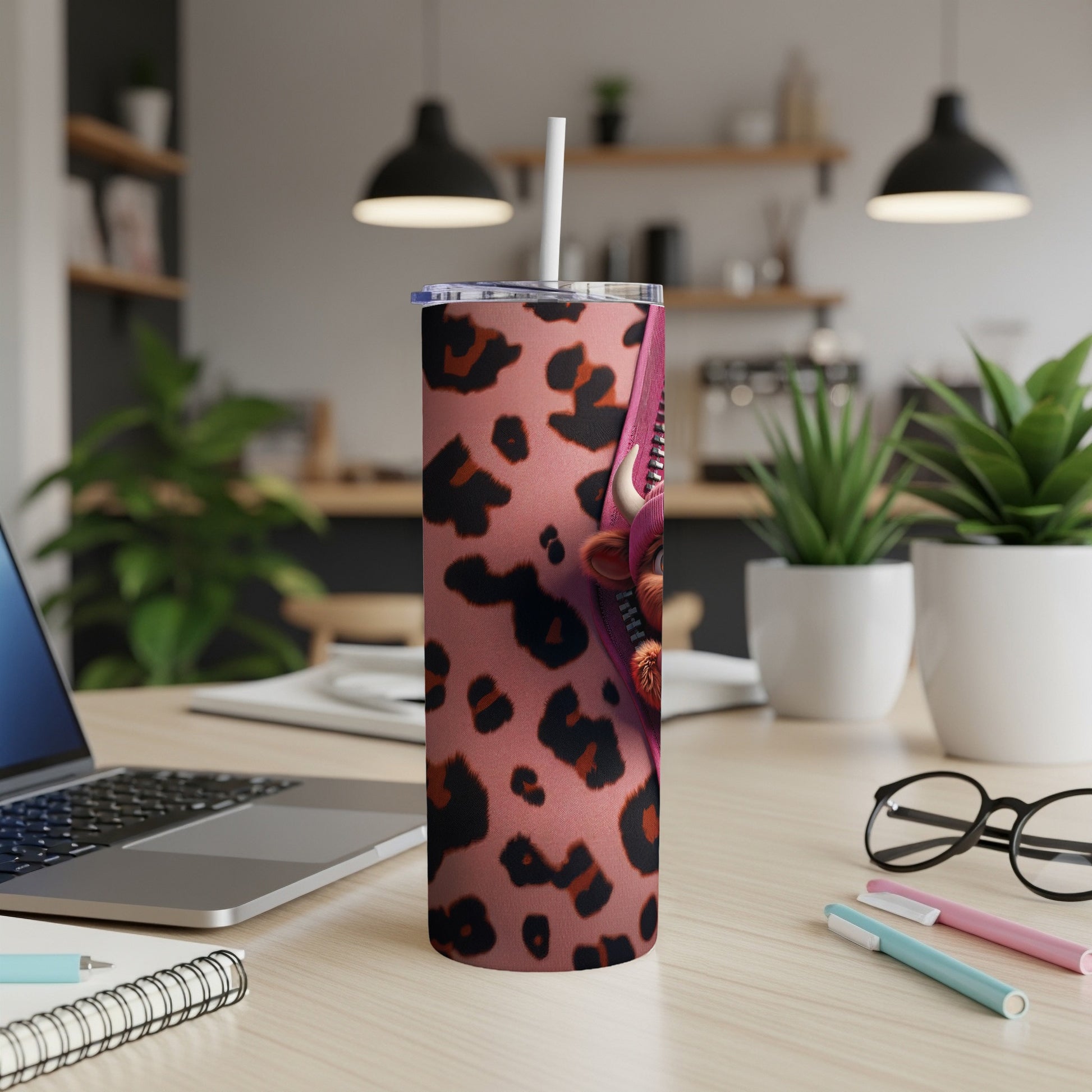 Pink leopard print tumbler with a cartoon face design.