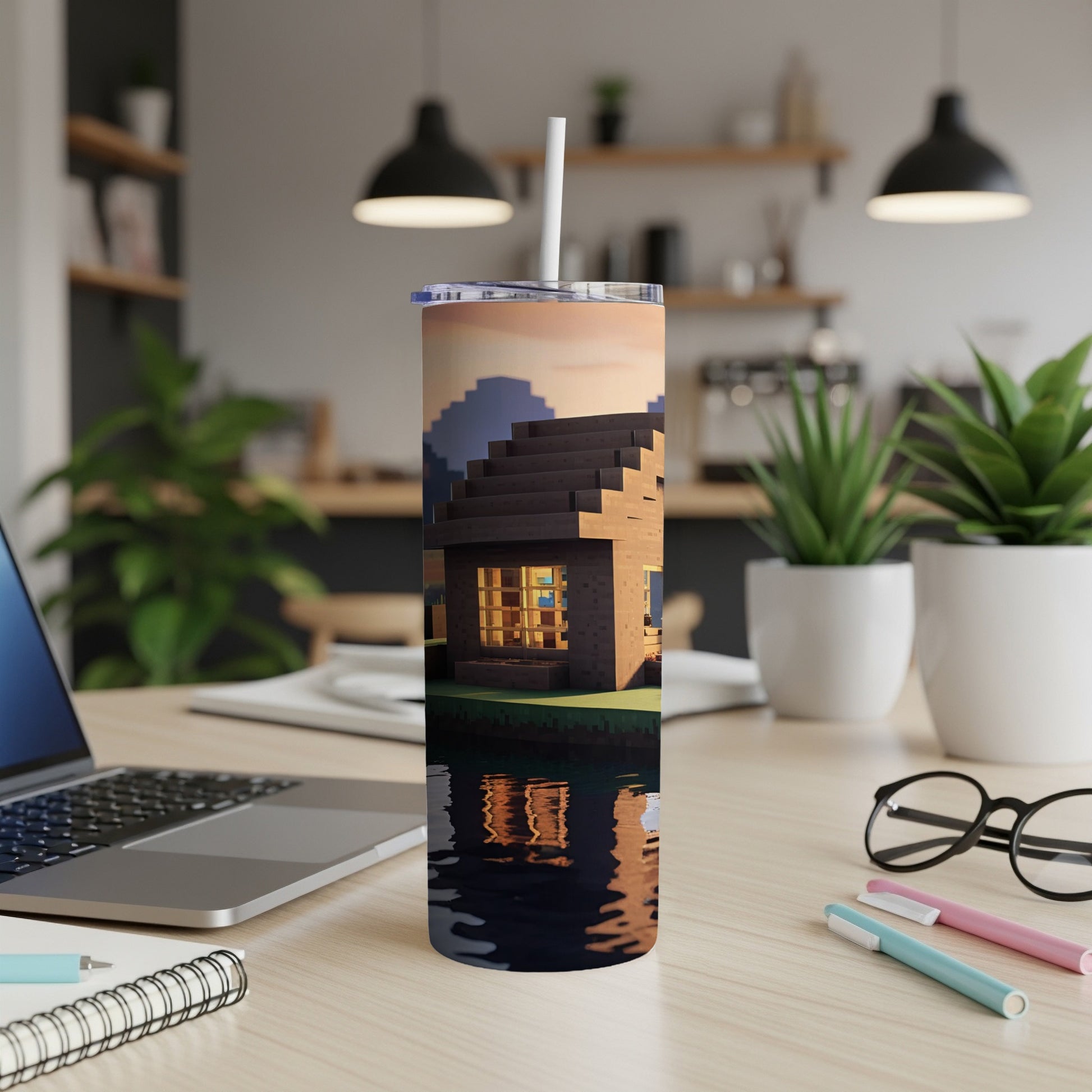 Minecraft-style house on water with sunset reflection, on a desk.