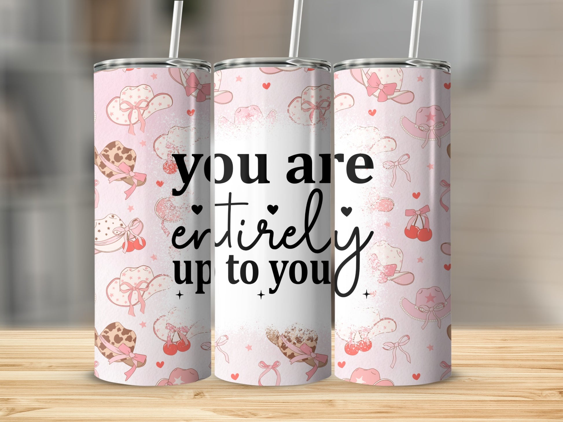 Pink tumbler with cowboy hats, cherries, and the text "you are entirely up to you."