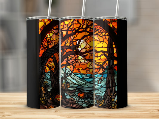 Three tumblers display a stained-glass scene of trees and pumpkins against a sunset.