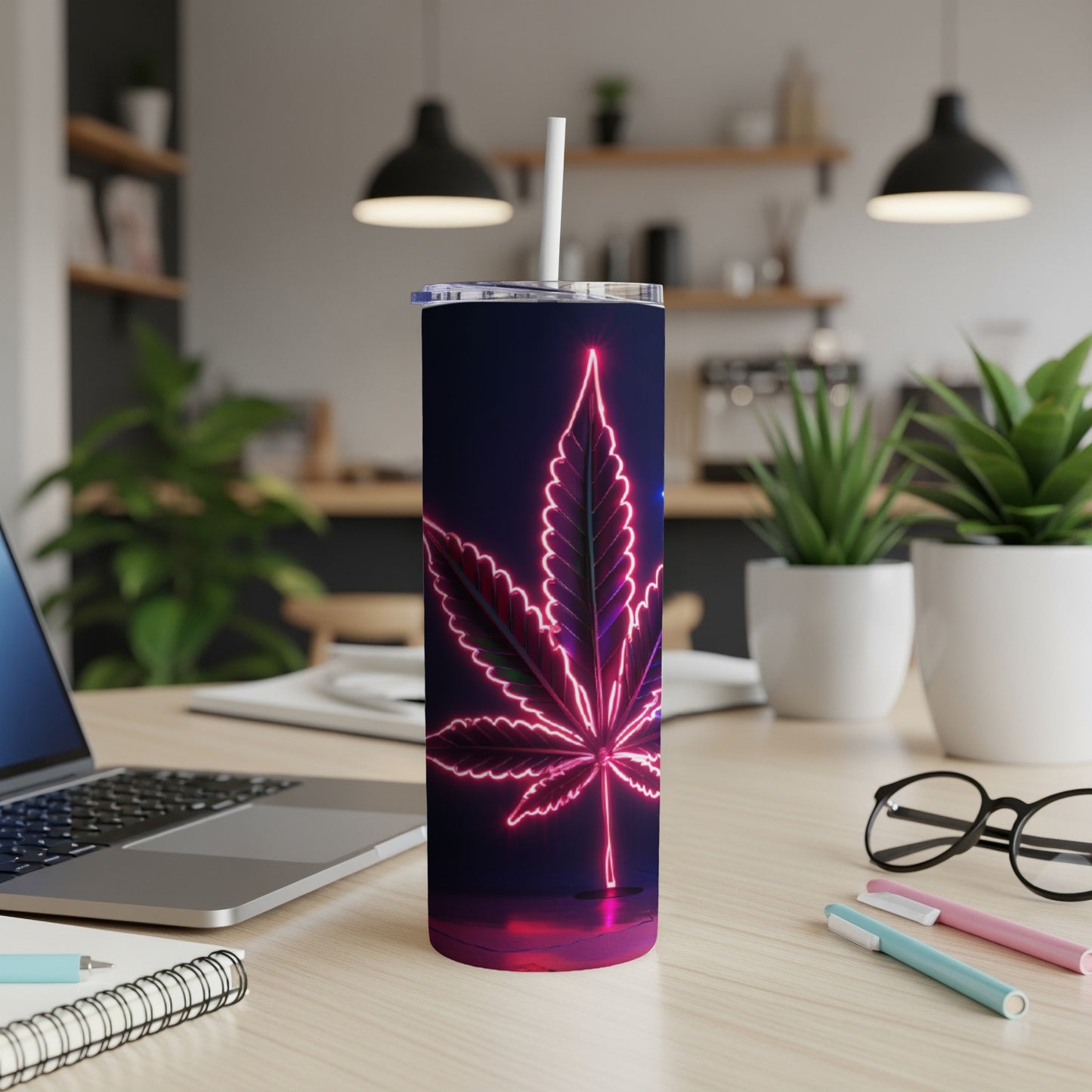 Neon pink cannabis leaf design on a dark background, on a travel tumbler.