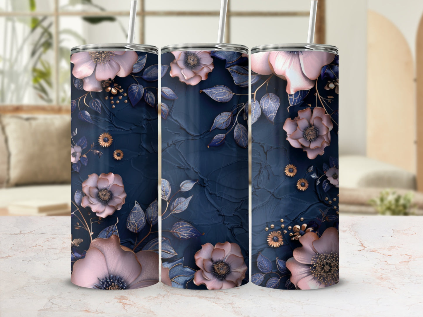 Three dark blue tumblers with pink floral and gold leaf designs.