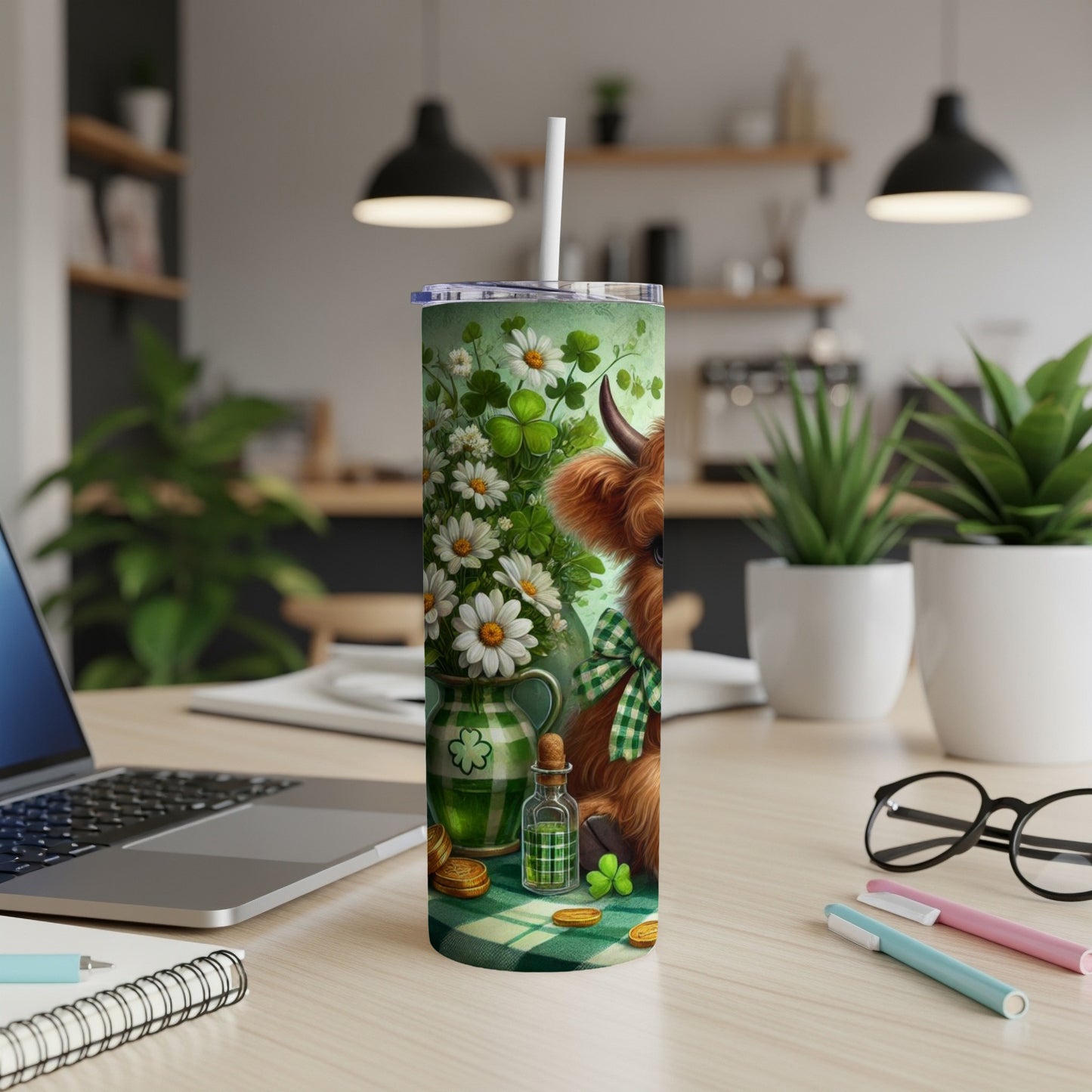 Highland cow with shamrocks and daisies on a green tumbler.