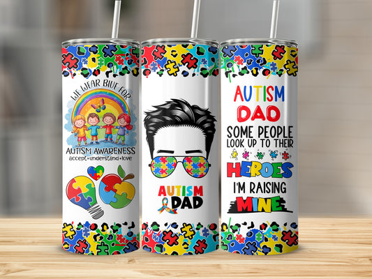 Tumbler with autism awareness puzzle pieces and graphics, "Autism Dad" text.