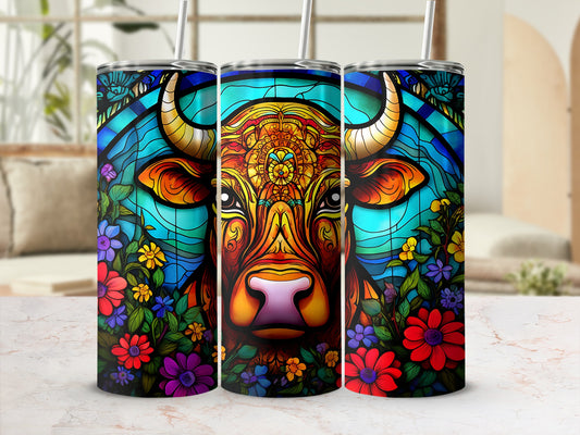 Bull face with floral border on a cylindrical tumbler with straw.