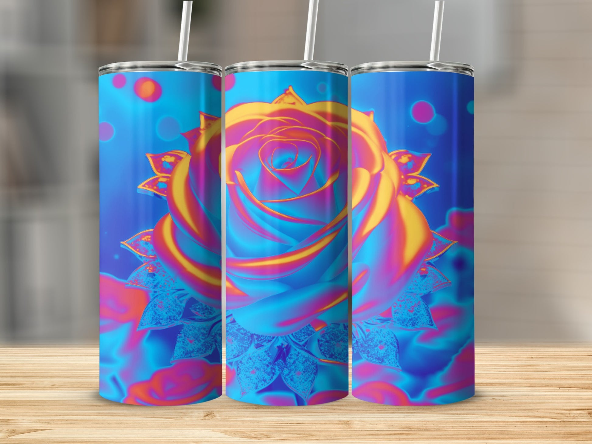 Three tumblers with vibrant floral rose design on a wooden surface.