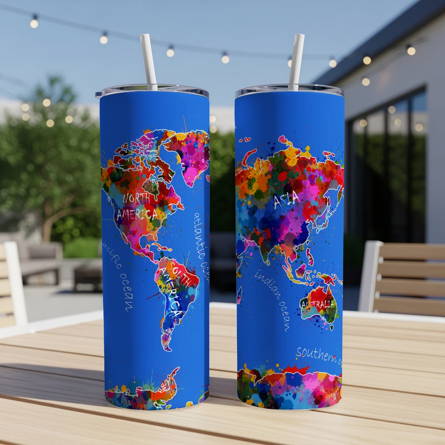 Blue tumblers with colorful world map design and white straws.