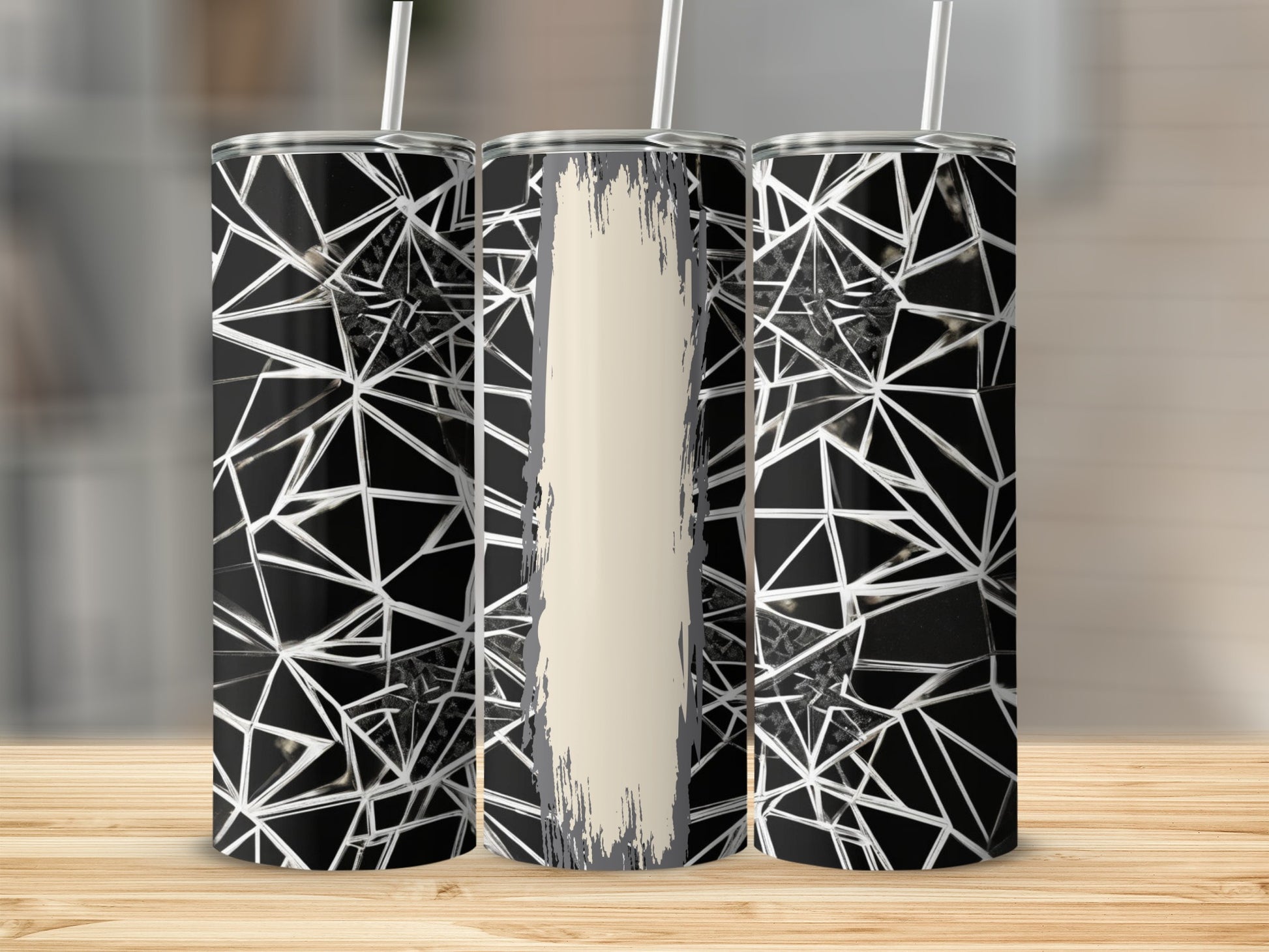 Three tumblers with a geometric black and white pattern and a cream-colored accent strip.