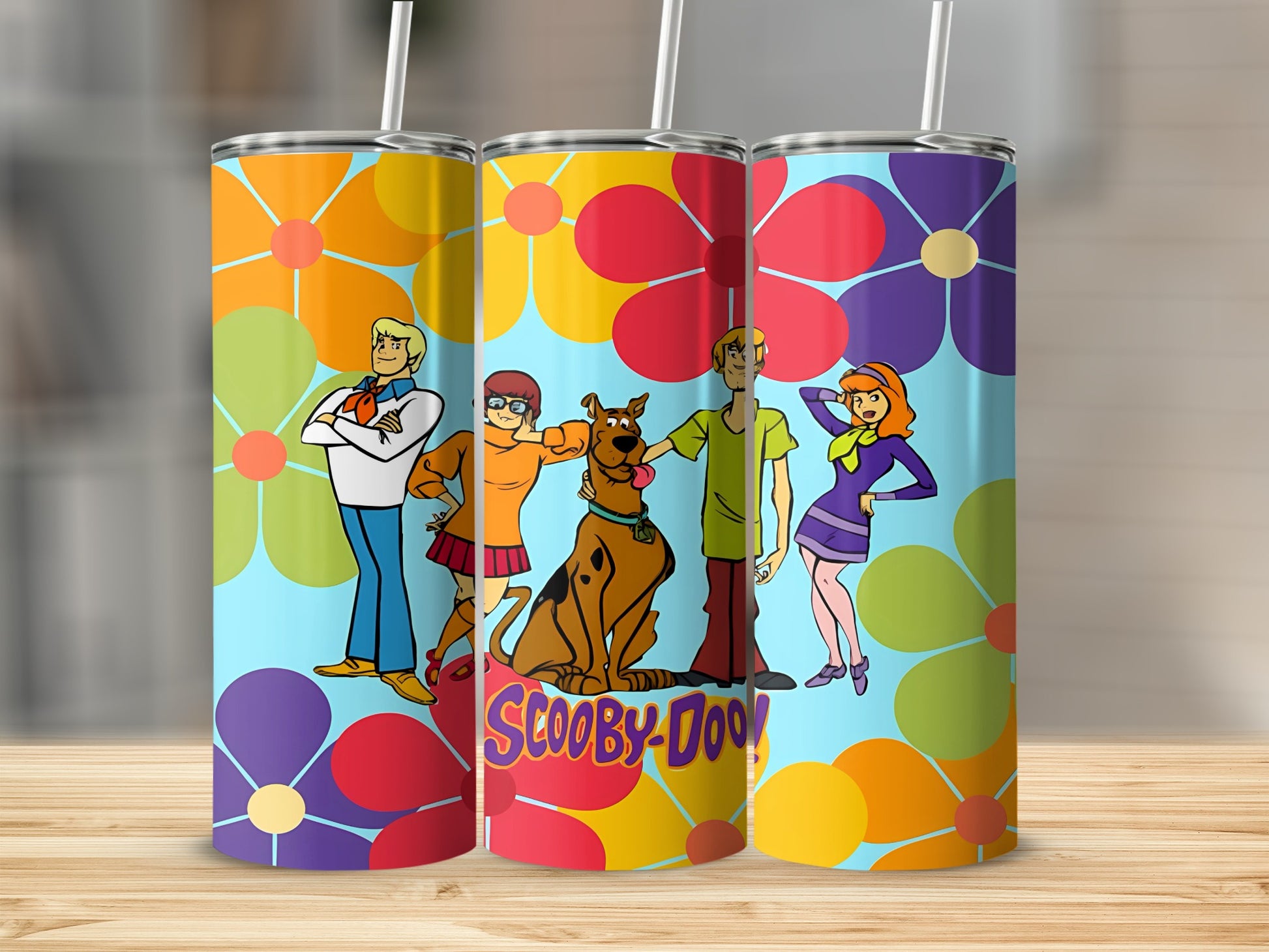 Scooby-Doo characters and floral pattern on three tall tumblers.