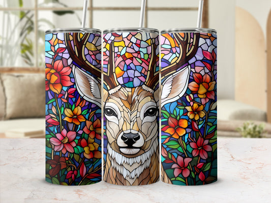 Stained glass deer portrait surrounded by colorful flowers on a tumbler.