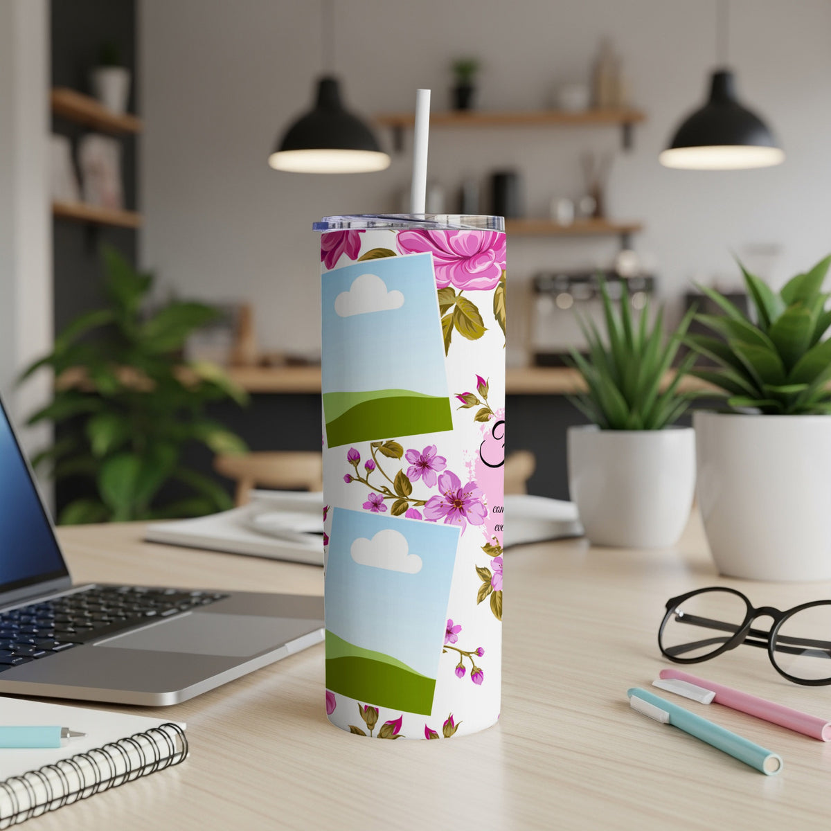 White tumbler with pink floral pattern and stacked photo frames.