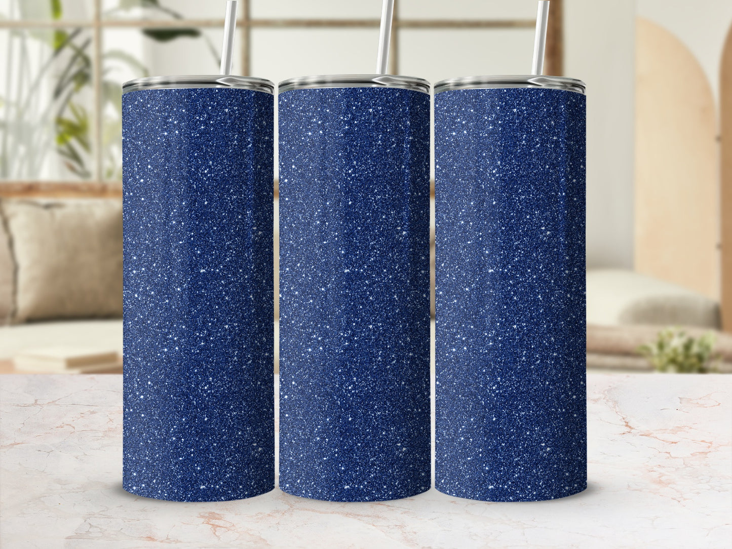 Three navy blue tumblers with white glitter speckles and silver lids, each with a straw.