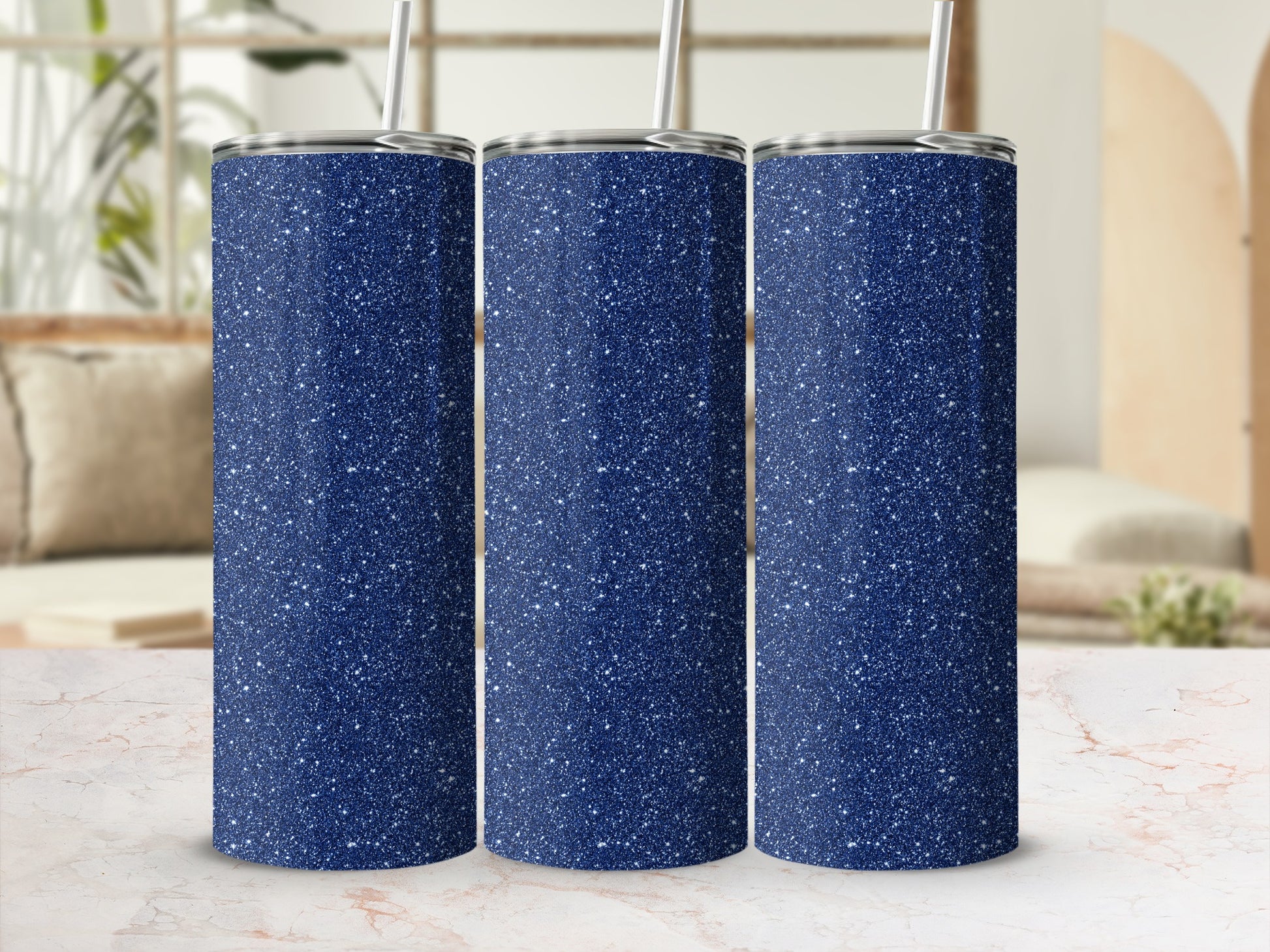 Three navy blue tumblers with white glitter speckles and silver lids, each with a straw.