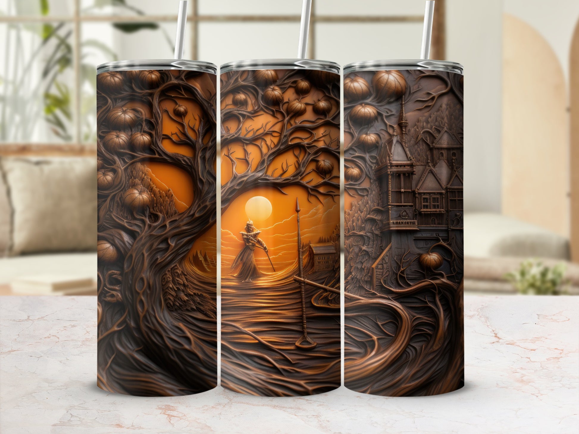 Three tumblers with embossed Halloween designs of trees, pumpkins, and a castle.