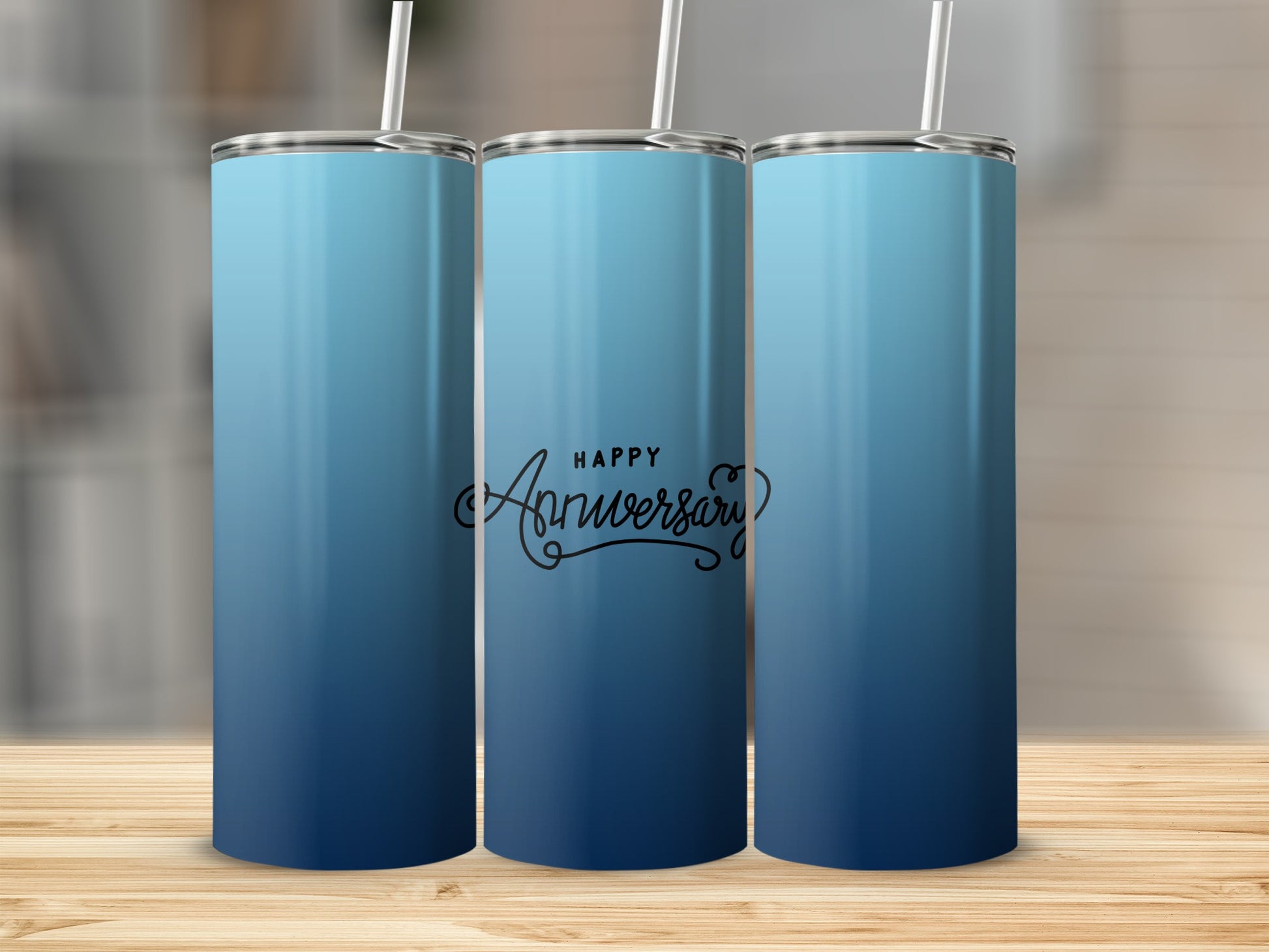 Three blue gradient tumblers with "Happy Anniversary" script on the middle one.