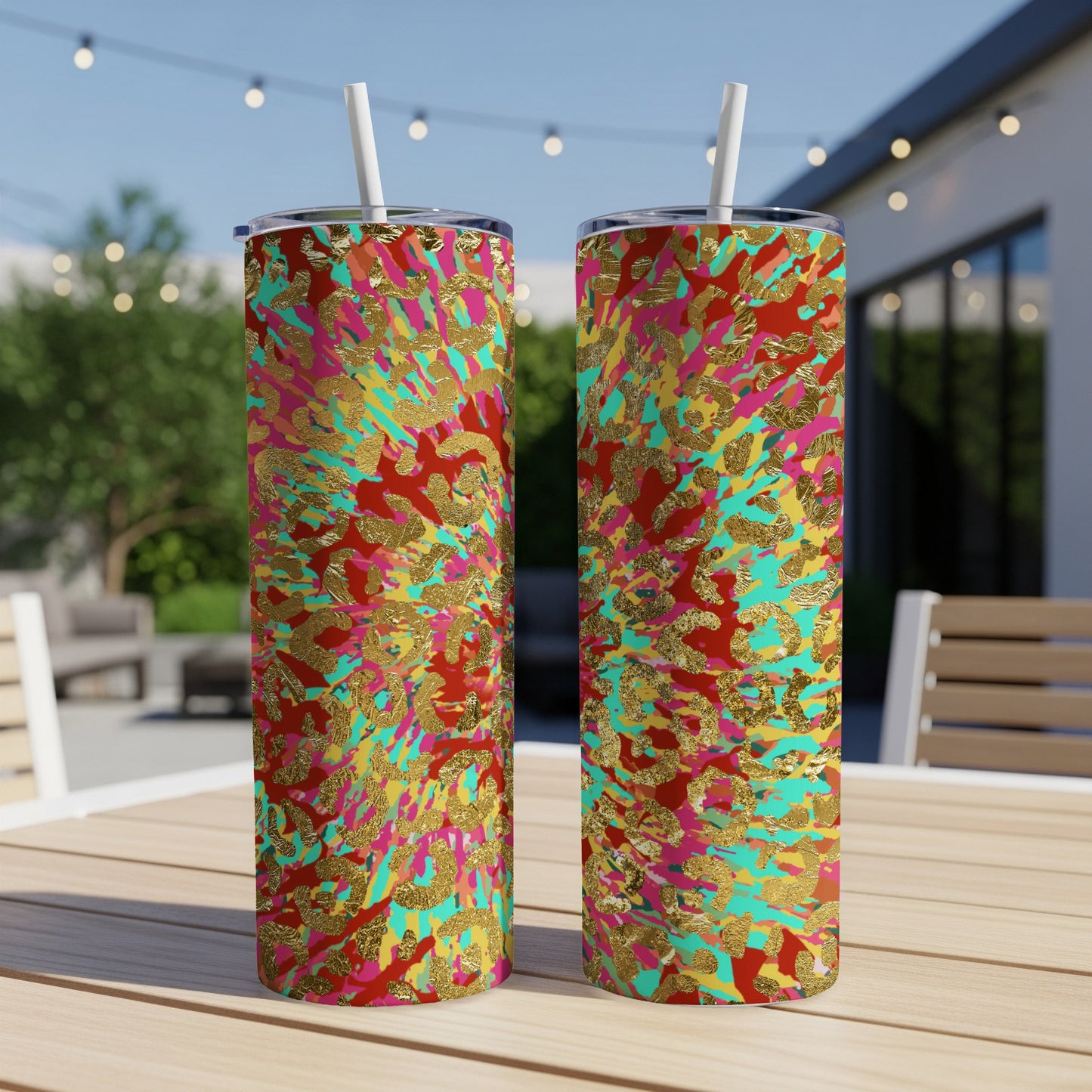 Two tall tumblers with a vibrant red, pink, turquoise, and gold abstract splatter pattern.