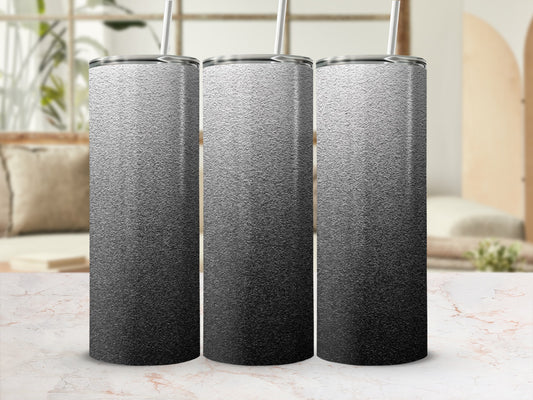 Three silver and black gradient tumblers with straws, displayed on a marble surface.