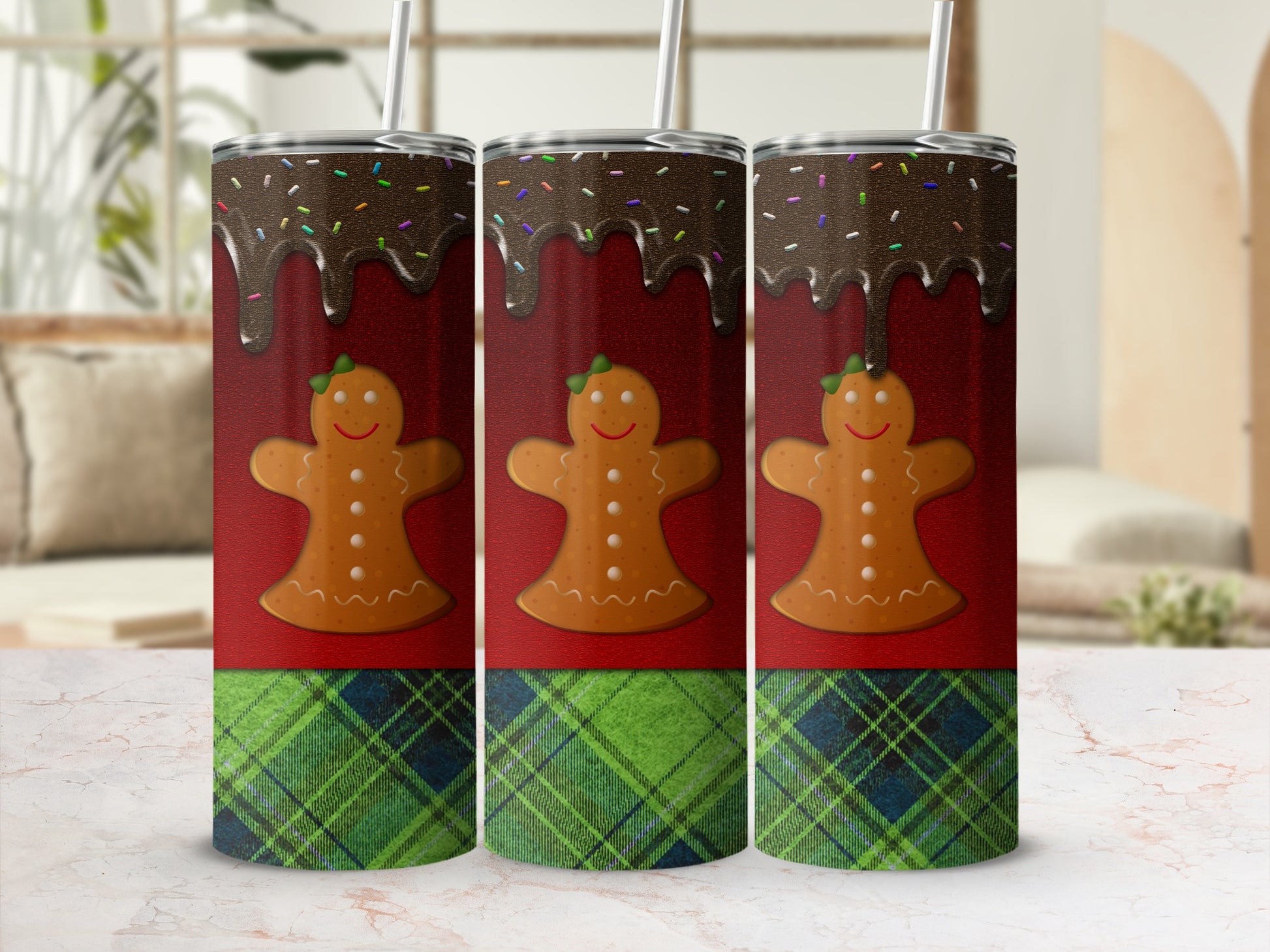 Three gingerbread cookies with chocolate glaze and sprinkles on a plaid background.