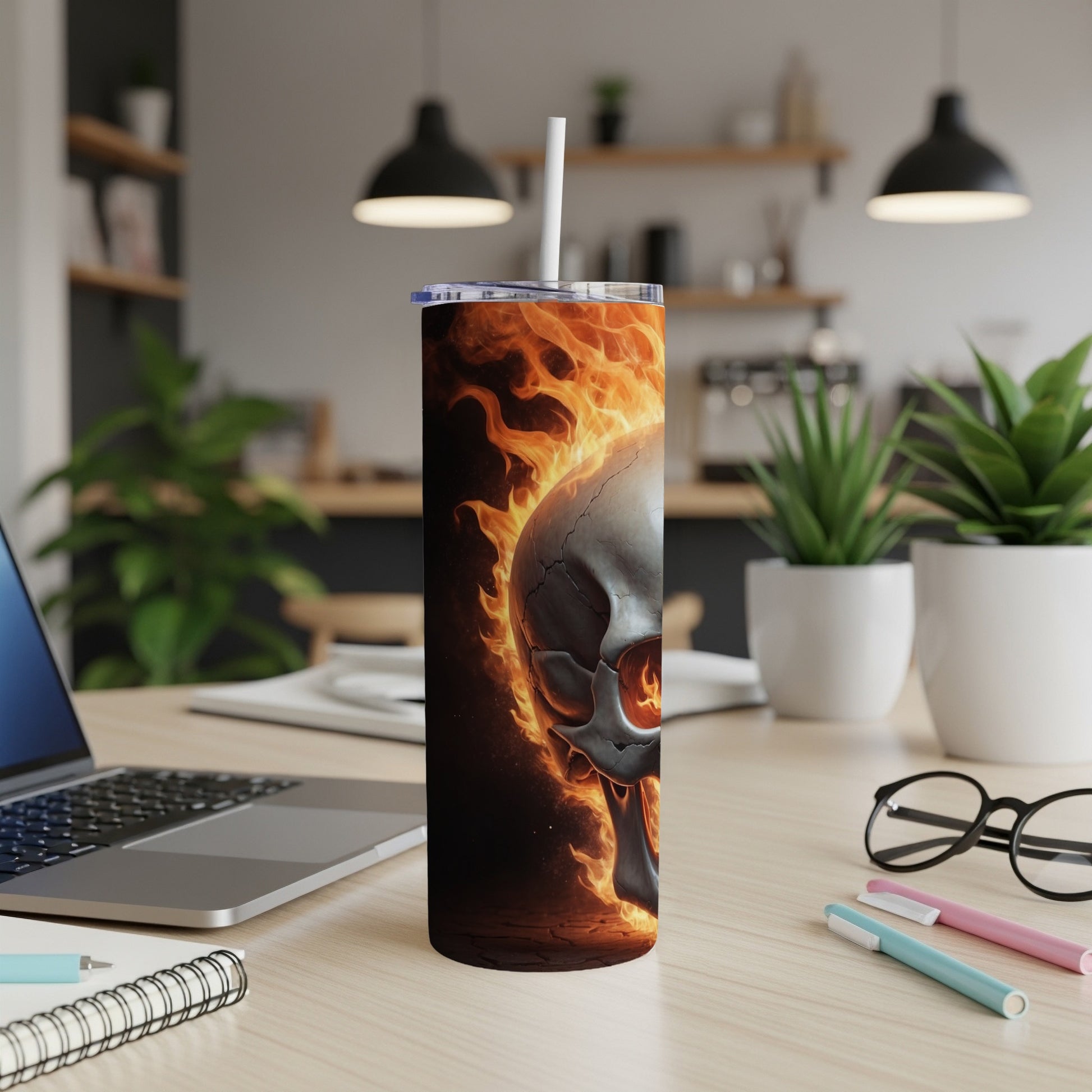 Flaming skull on a tumbler cup with a straw.