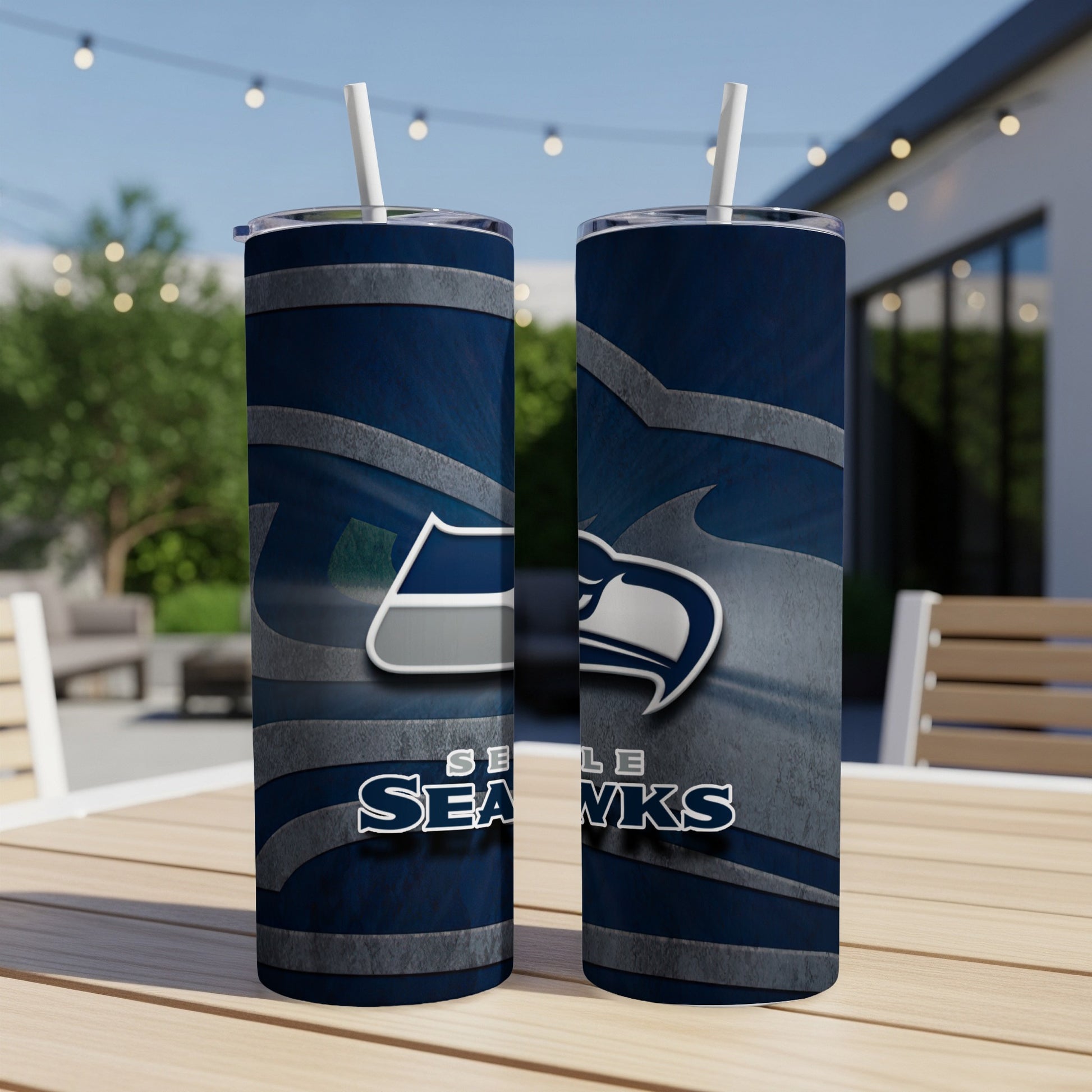 Seattle Seahawks logo on two navy blue tumblers with straws on a table.