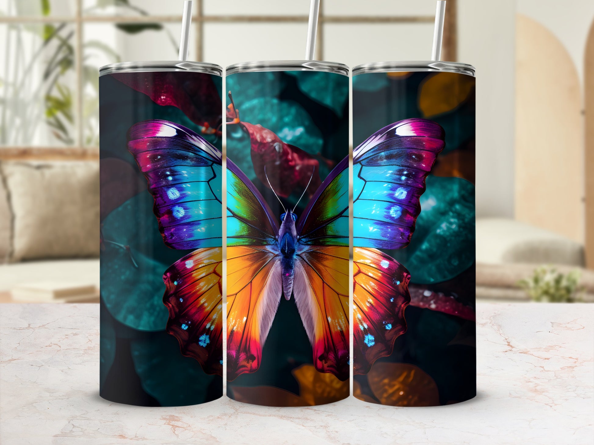 Three tumblers featuring a vibrant, colorful butterfly design on a dark, blurred background.
