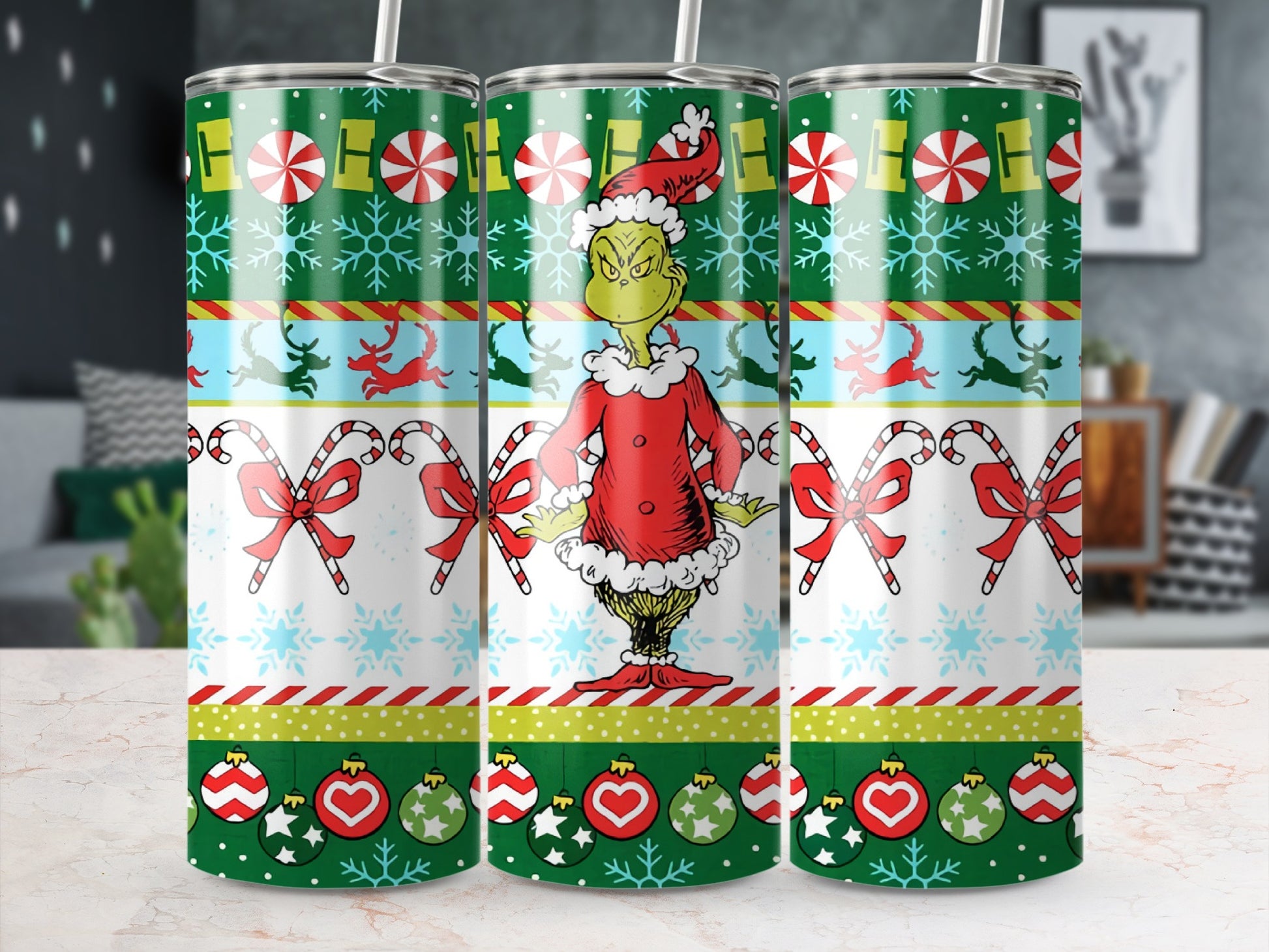 The Grinch in Santa outfit on a Christmas tumbler with candy canes and ornaments.