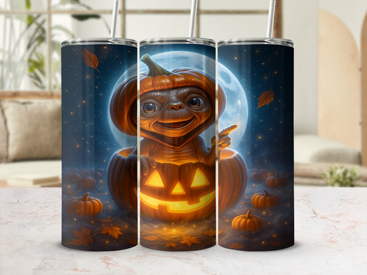 ET character wearing a pumpkin hat sits inside a jack-o'-lantern with a moonlit sky.