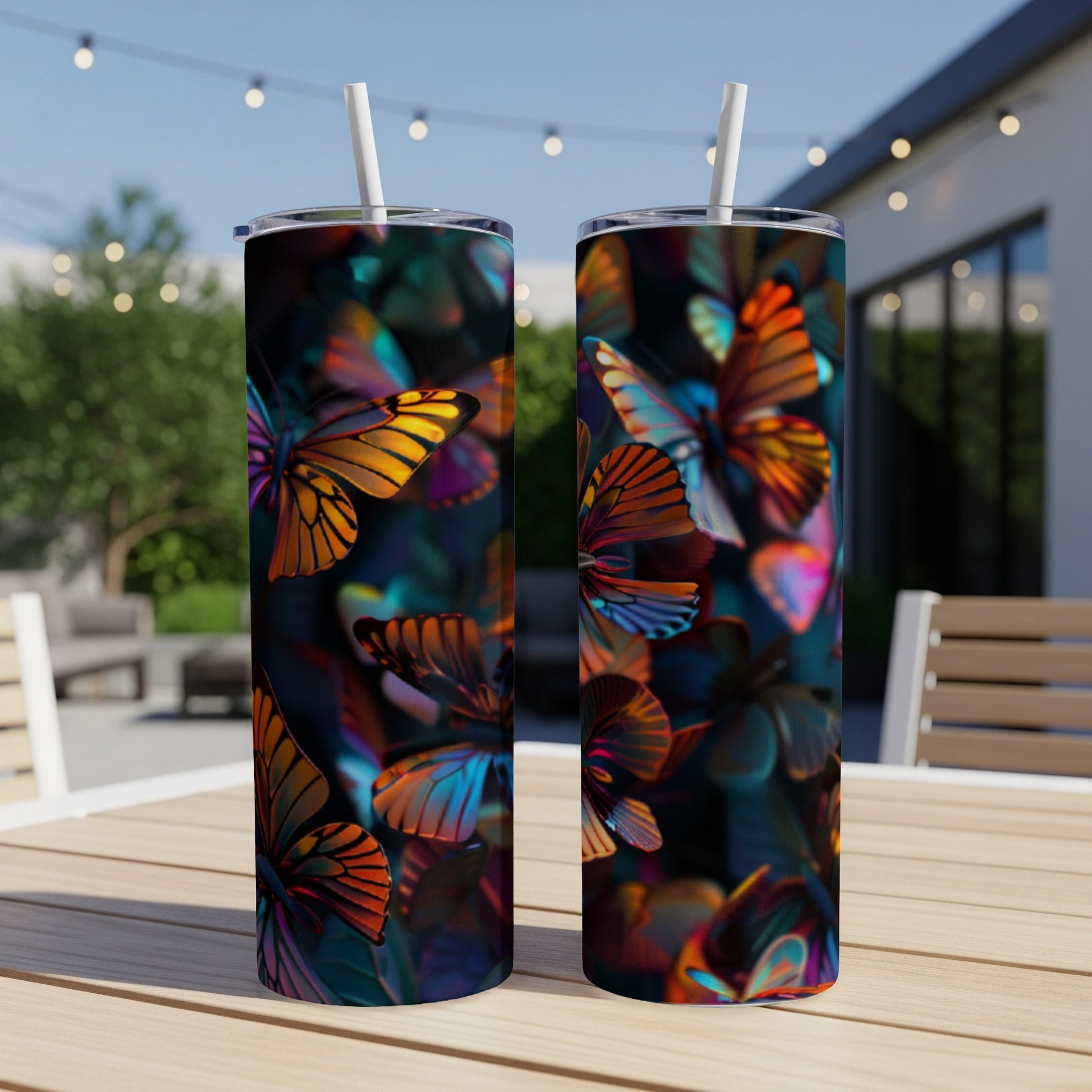 Two tumblers with colorful, iridescent butterfly patterns on a wooden table.