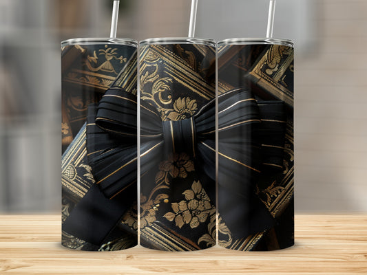 Tapered tumbler with black and gold ornate floral pattern and bow.