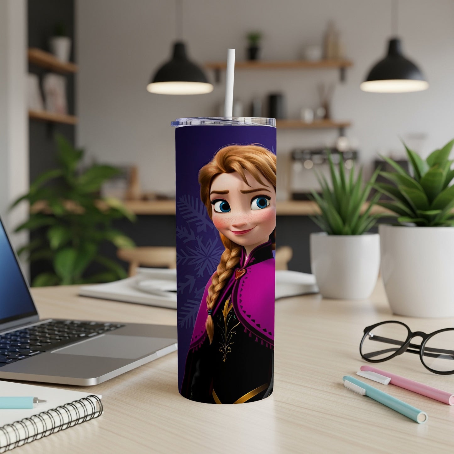 Anna from Frozen on a purple tumbler with a straw on a desk.