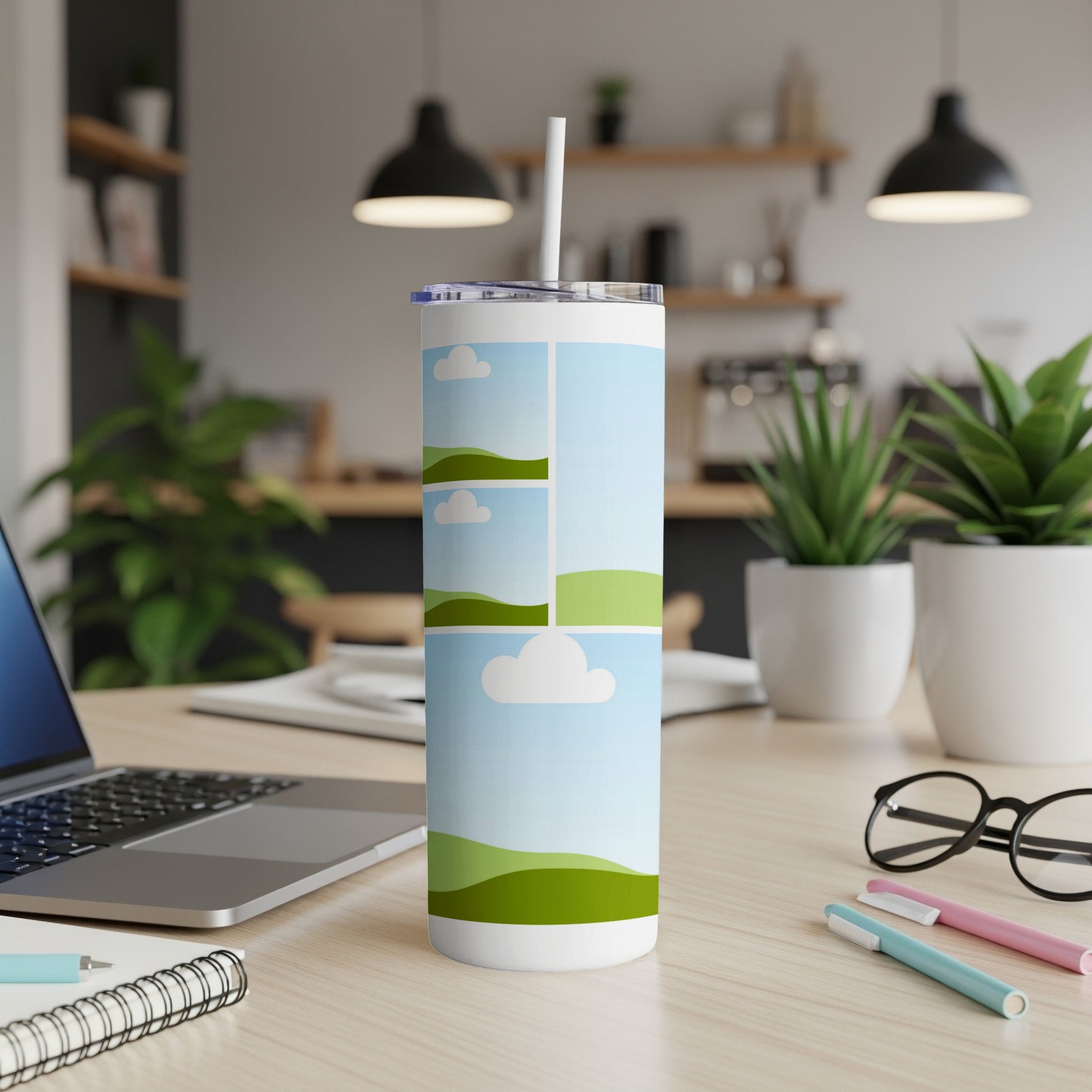 White tumbler with a collage of rolling green hills and sky with clouds.