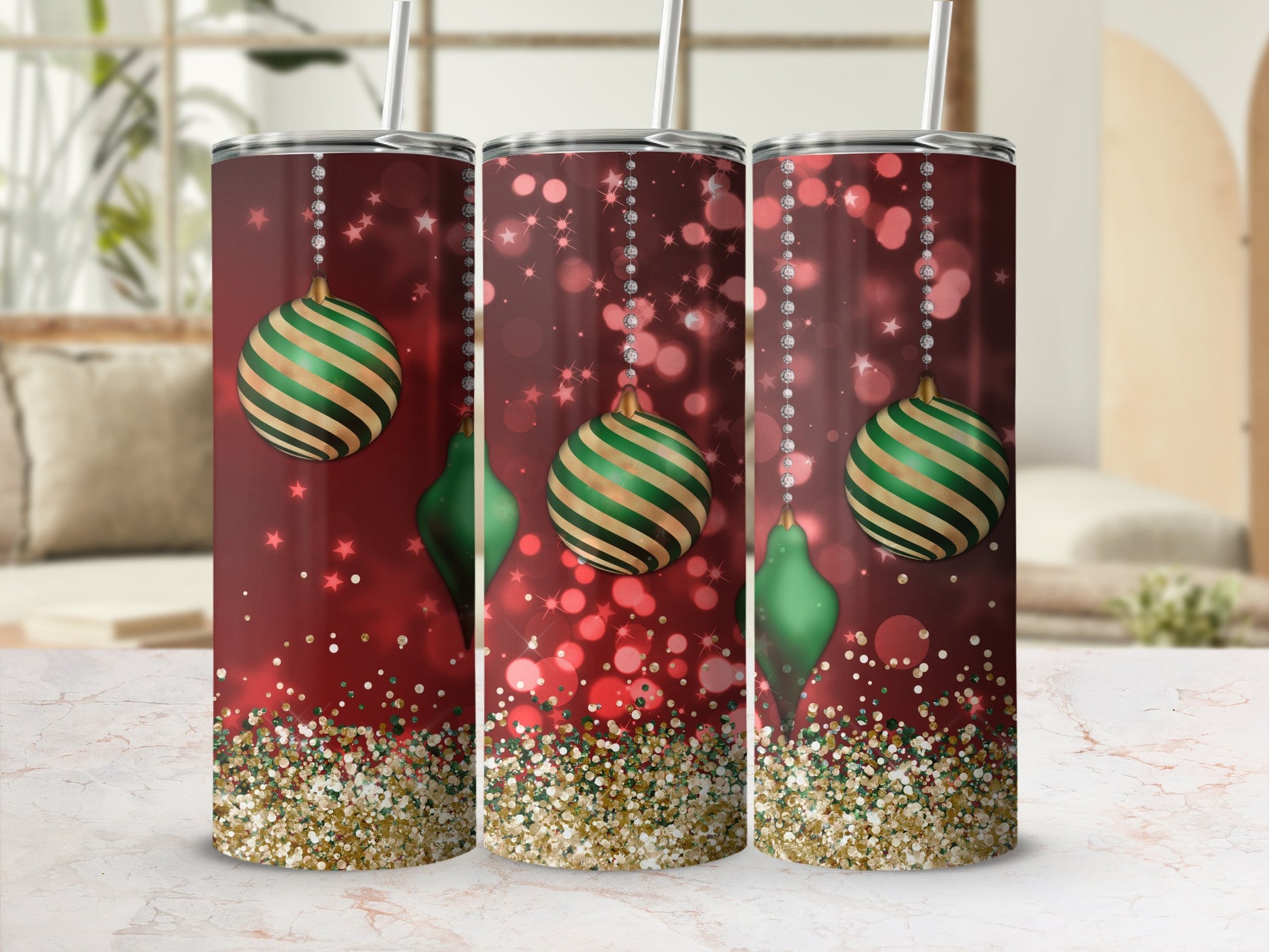 Red tumbler with green ornaments and gold glitter accents.