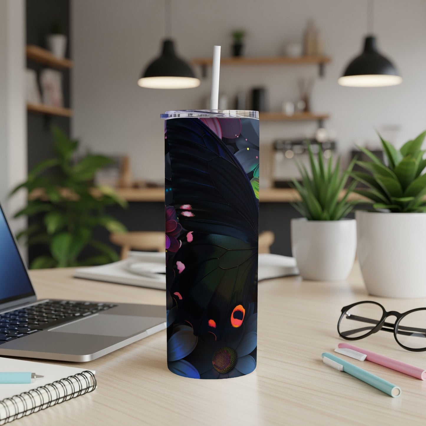 Black butterfly and floral pattern on a slim tumbler with a straw.