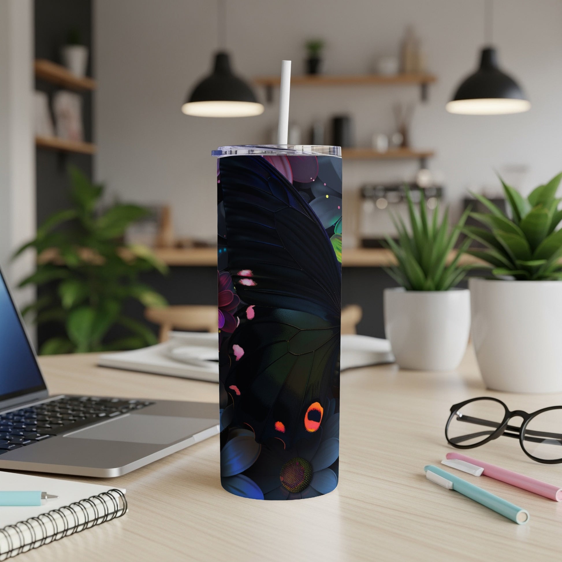 Black butterfly and floral pattern on a slim tumbler with a straw.