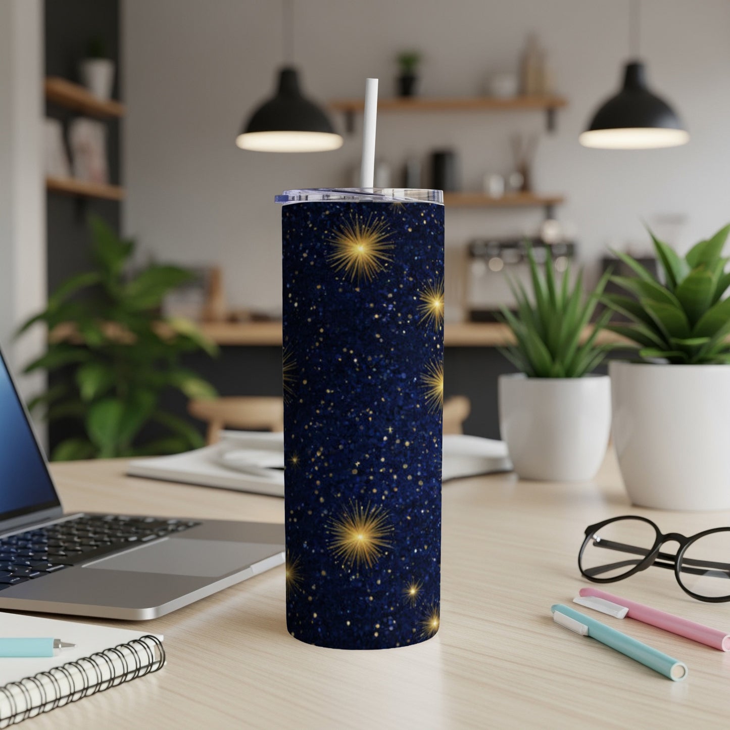 Dark blue tumbler with gold glitter stars and a white straw.
