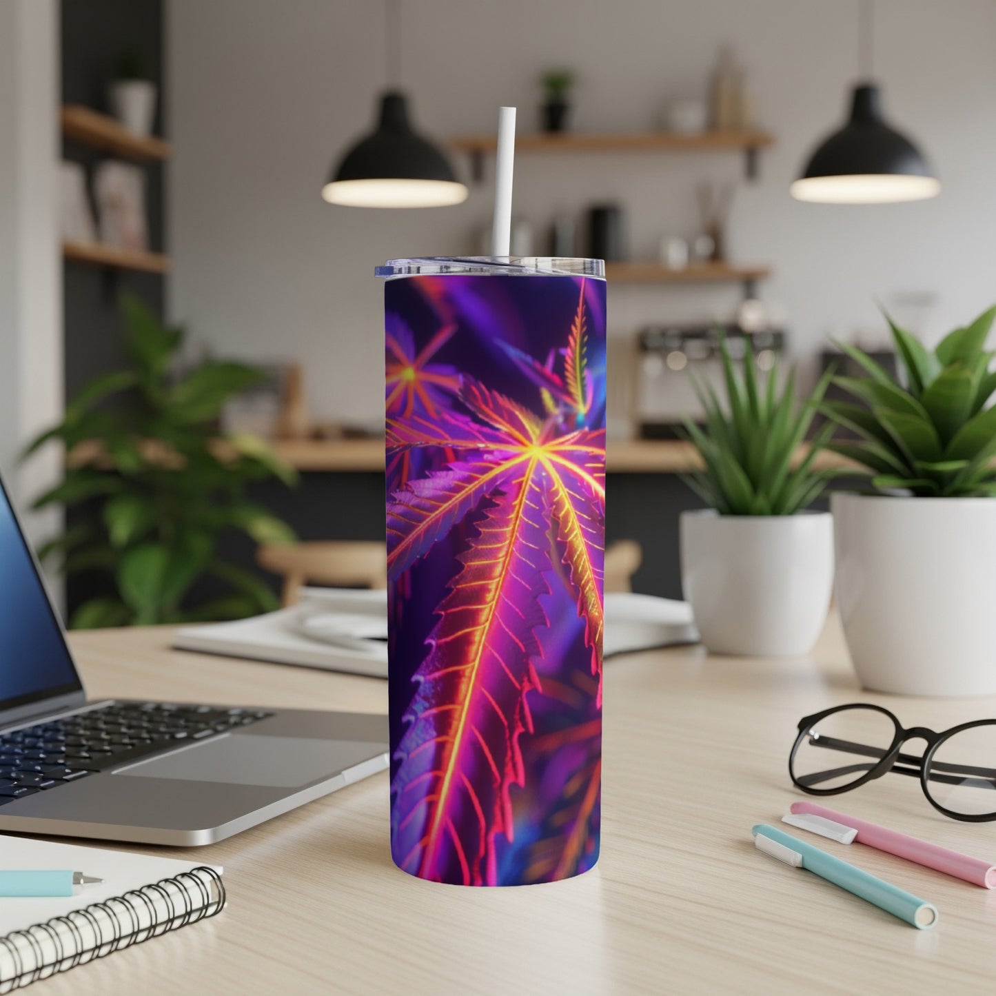 Purple and orange cannabis leaf pattern on a tall, slim tumbler with a straw.