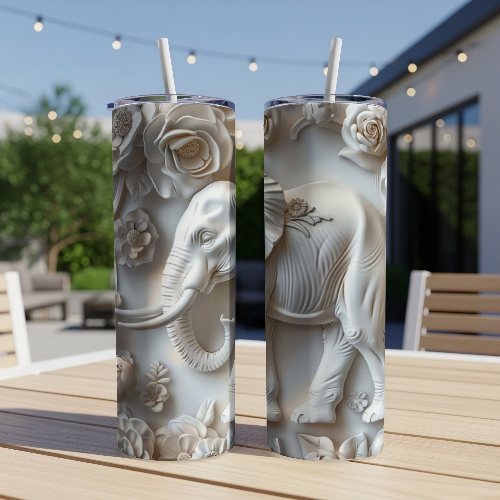 White embossed elephant and floral design on two tumblers with straws.
