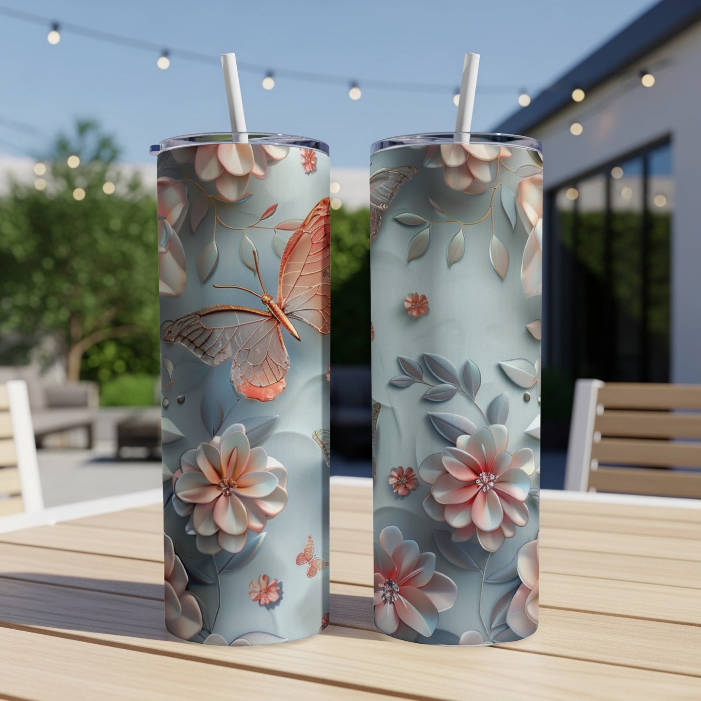 Two tall, thin tumblers with a pastel floral and butterfly pattern.