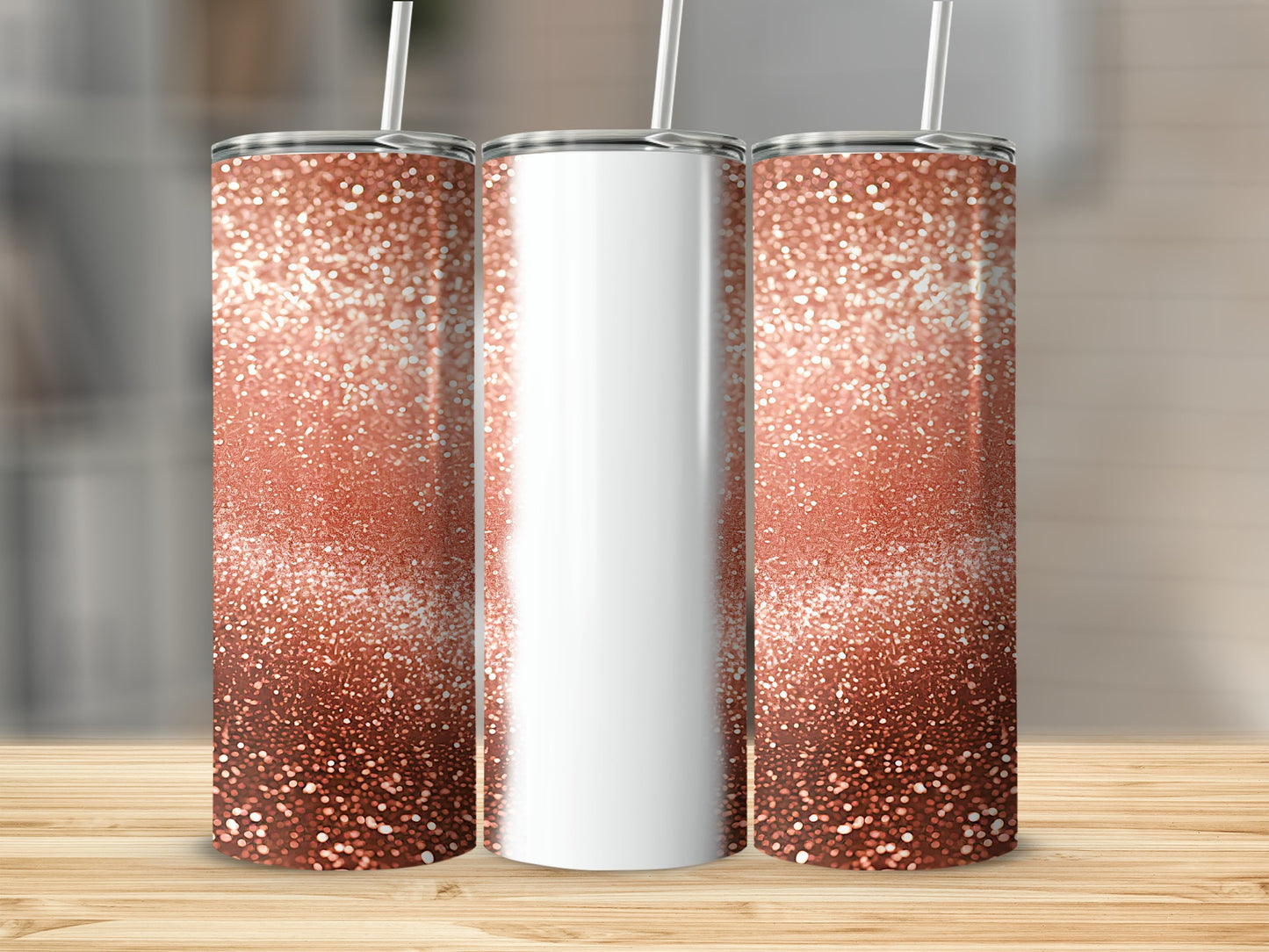 Three rose gold glitter tumblers with white straws on a wooden surface.